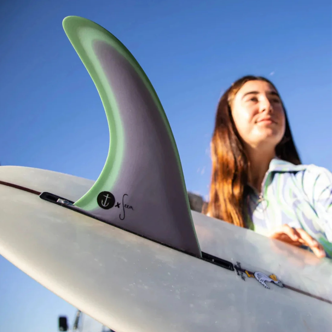 Surfer girl with single fin surfboard